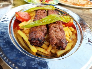 delicious Adana kebab and salads