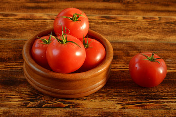 fresh delicious vegetables ripe red tomatoes on wooden background
