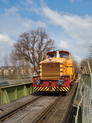 Old German Diesel Shunting Lokomotive rolling over a Railroad Bridge