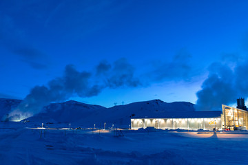 Night view. Thermal power plant building at a hot spring. Icelandic industry