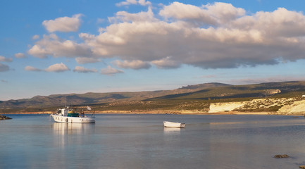fishermen boats under dramatic sky in landscape scenery at Mediterranean Sea