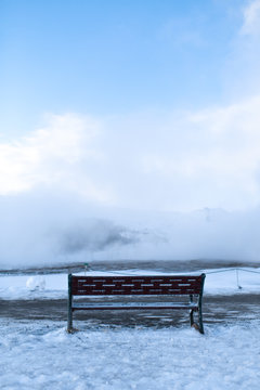 Bench for rest overlooking a cloud of steam in winter © Kate