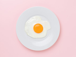 fried egg on pink background