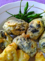green chilies and several kinds of Indonesian snacks on the plate. selected focus.