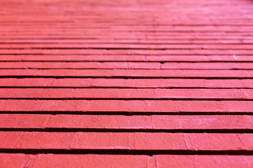 Background of horizontal stripes of wood planks painted in faded red