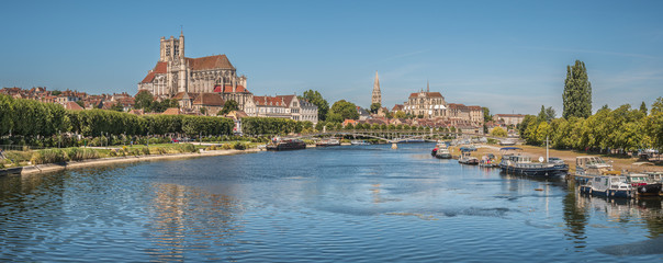 Beautiful shot of the Auxerre Cathedral near the Yonne river on a sunny afternoon in France