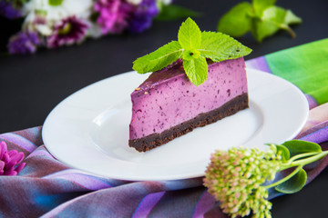 Homemade cheesecake with fresh blueberries and mint for dessert - healthy organic summer dessert pie cheesecake. Creative atmospheric decoration