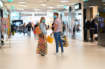 Shopping at the time of Corona Virus. Handsome young and fashion couple at the shop center walking...