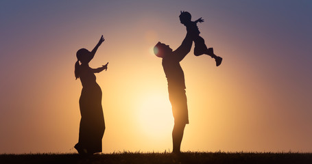 Happy family playing together with father holding up son in the air. Parent child relationships concept. 
