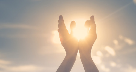 hands in the sky holding the sun. Spiritual healing concept.  - Powered by Adobe