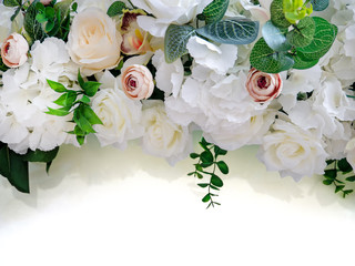 Festive composition of white roses on a white background with a copy of the space. Flat flat, top view.