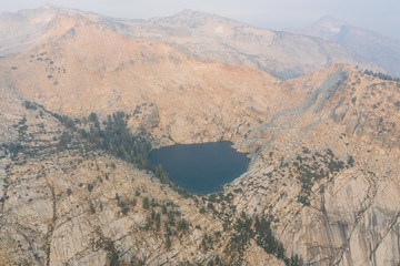 A scenic lake is found amid the wilderness of the Sierra Nevada Mountains. Running along the...