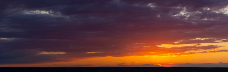 Obraz premium Purple-magenta clouds. Tragic gloomy sky. Landscape with bloody sunset. Fantastic skies on the planet earth. Twilight, nightfall. Blackout.