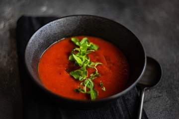 Gazpacho soup served in black bowl