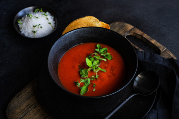 Gazpacho soup served in black bowl