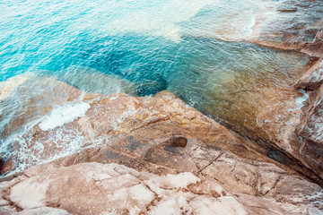 Rocky beach and turquoise water of Tirrenian sea in Baratti, Tuscany, Italy. Cliff Buca delle Fate. Tourism destination.