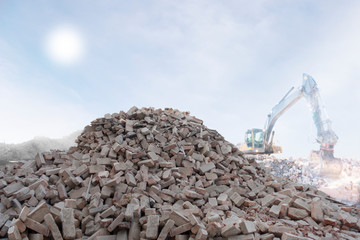 heap of bricks and excavator