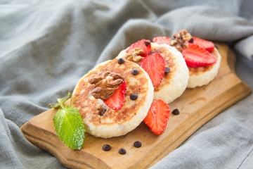 A healthy breakfast of pancakes, strawberries, chocolate, and honey