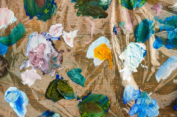 Colorful oil paint palette on cellophane