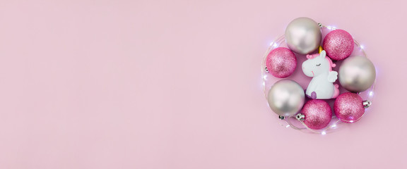 Christmas tree toys and balls surrounded by light garland. New year banner. Copy space