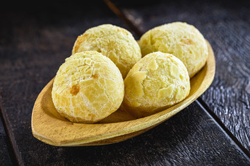 Brazilian cheese bread, inside an artisanal wooden bowl, small bread baked in an oven. Traditional delicacy from the state of minas gerais.