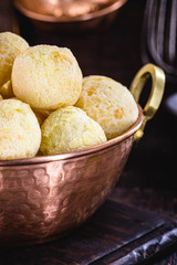 Brazilian cheese bread, in copper pan, small bread baked in oven. Traditional delicacy from the state of minas gerais.
