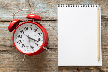 Shopping time concept. Shopping cart and a stopwatch on an old wood background with a copy space...