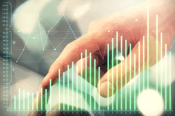 Multi exposure of man's hands holding and using a phone and financial chart drawing. Market analysis concept.