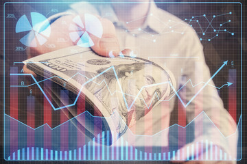 Multi exposure of financial graph drawing hologram and USA dollars bills and man hands. Analysis concept.