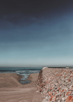 Panoramic shot of the Sabon beach Galicia in Spain with a thin cloud background