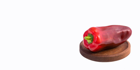 Capsicum annuum - Organic fresh bell pepper on wooden plate