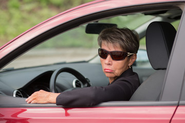 Fashion business senior woman driving red car