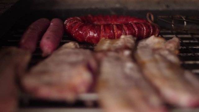 cooking grilling steak sausage on a grill