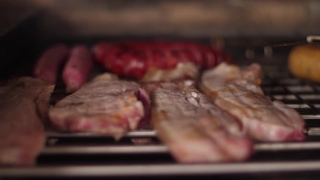 cooking grilling steak sausage on a grill