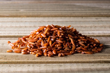 red rice isolated on wooden table in Brazil