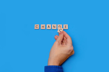Change to chance  / Chance to change wooden letters on a light blue background