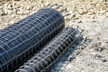 geogrid rolled into a roll, material for road surface repair
