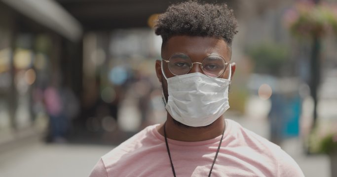 Young Black Man In City Wearing A Mask