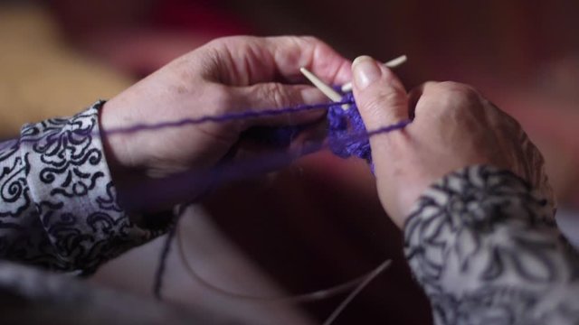 ederly woman hands Knitting doing crochet 