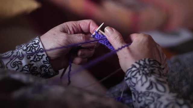 ederly woman hands Knitting doing crochet 