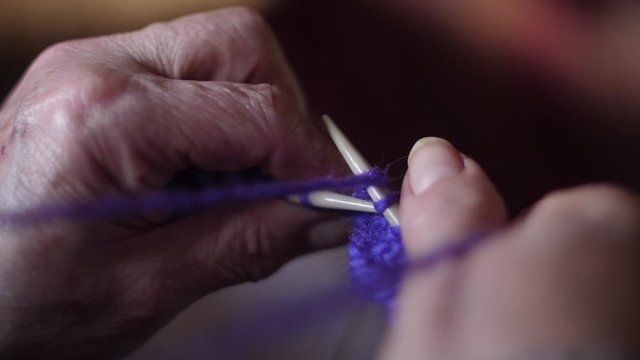 ederly woman hands Knitting doing crochet 