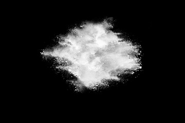 Obraz na płótnie Canvas Freeze motion of white color powder exploding on dark background. 