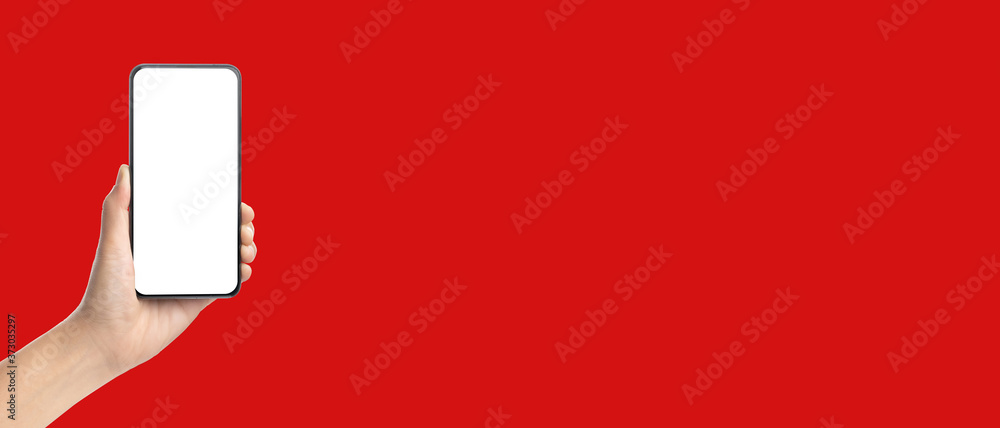 Aufkleber mockup hand holding mobile blank screen on red background.mockup banner display of content to advert