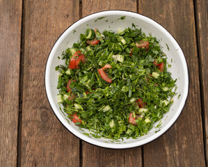 Summer salad of various herbs - good for health. Wooden Background