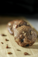 Homemade sweet chocolate cookies on wooden table with black background