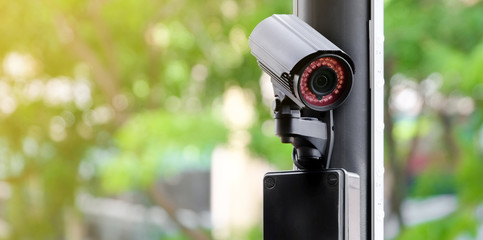 Modern public CCTV camera on a electric pole with blurred natural background. Intelligent...