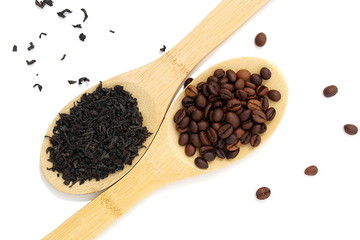 Dry herbal tea and coffee beans lie on wooden spoons and on a white background