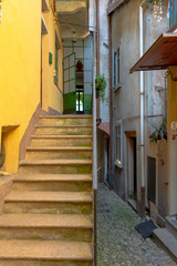 ISOLA BELLA, ITALY - Jul 30, 2020: Old stairs and building with an open door in a small town in Italy.
