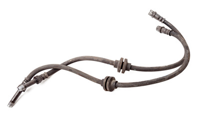 Pair of old brake hoses on white background in photo studio - a high-pressure hose with fluid and metal nozzles for replacement during repairs or for catalog of spare parts for sale on auto parsing.