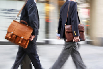 Fototapeta premium motion blurred business people walking on the street